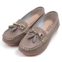 Pair of beige moccasins  with decorative gold bars and tassels on a white background