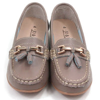 Pair of beige moccasins  with decorative gold bars and tassels on a white background