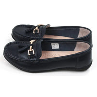 Pair of navy blue loafers with gold accents. Side view.