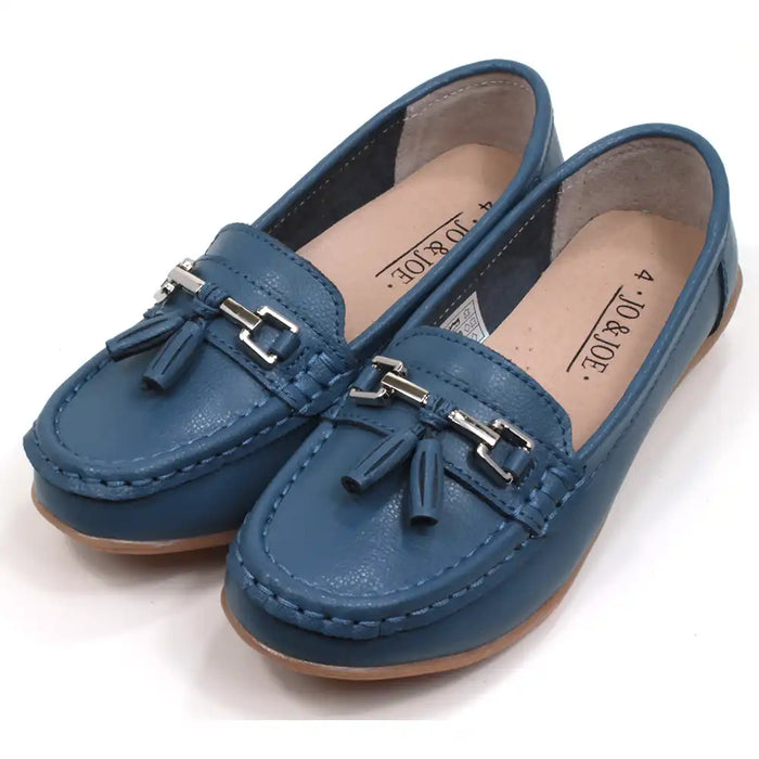 Joe and Jo moccasin style slip on, leather shoes in china blue colour. Over the foot metallic gold coloured  detail and two matching tassels. Beige rubber soles. Angled view.