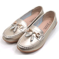 Joe and Jo moccasin style slip on, leather shoes in metallic gold colour. Over the foot metallic gold coloured  detail and two matching tassels. Beige rubber soles. Angled view.