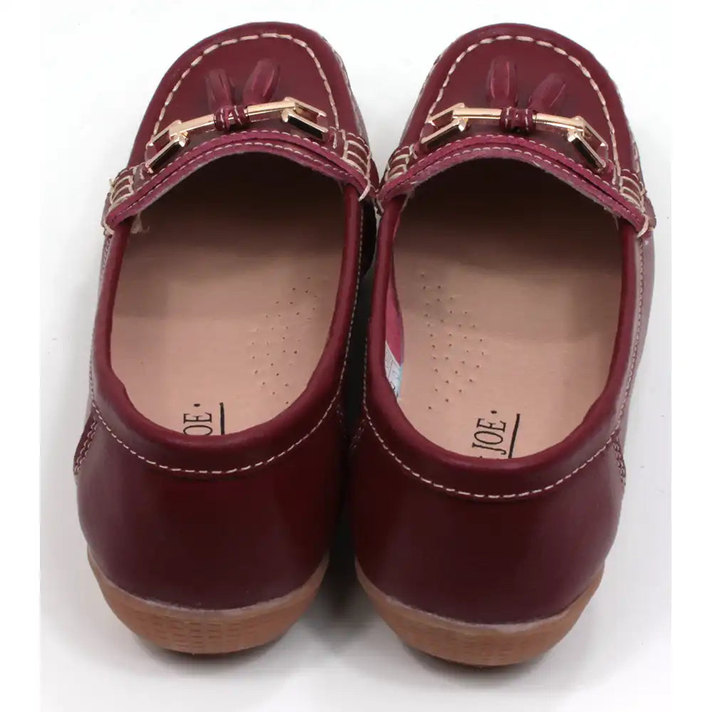 Joe and Jo moccasin style slip on, leather shoes in red wine colour. Over the foot metallic gold coloured  detail and two matching tassels. Beige rubber soles. Back view.