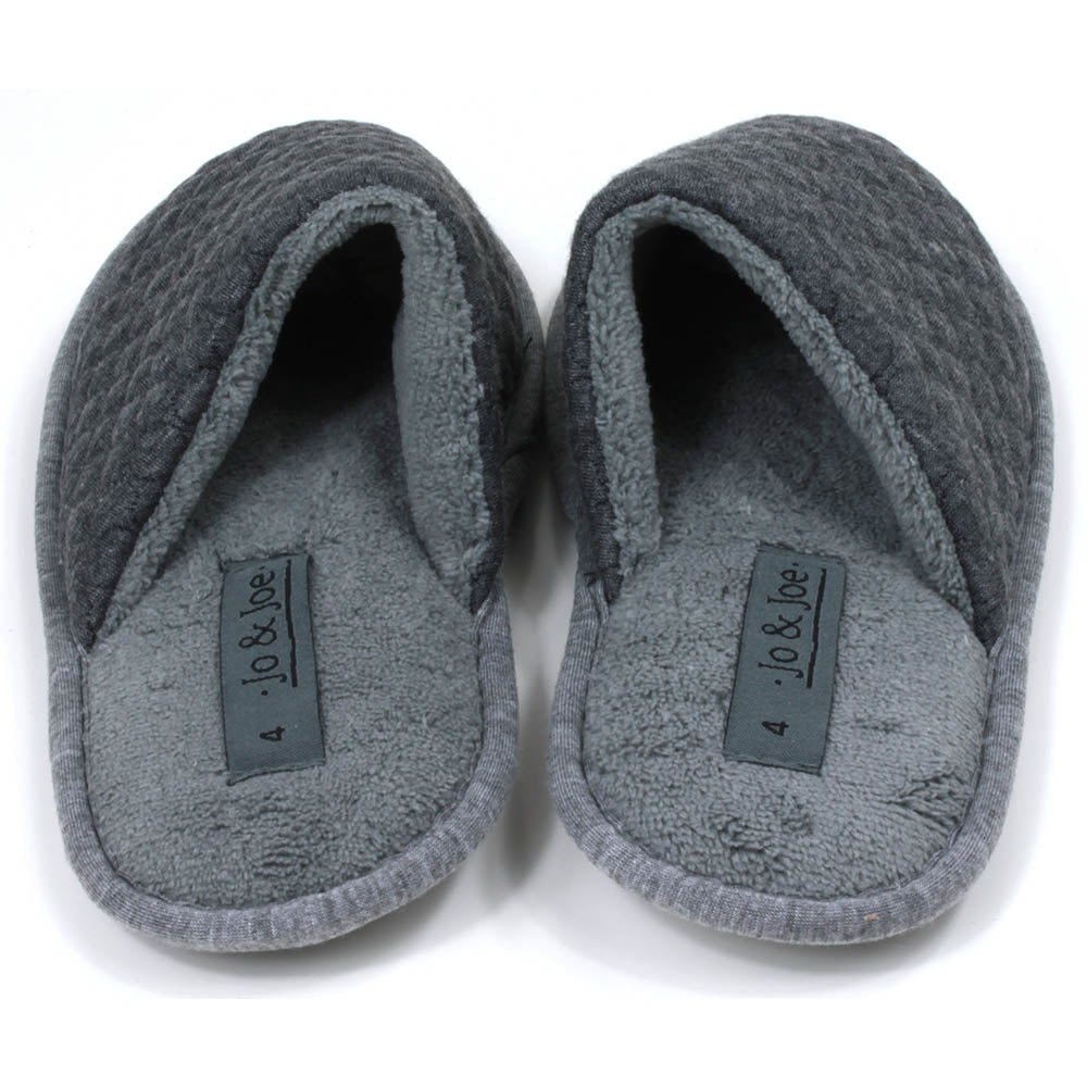 Grey mule slippers with sculpted waffle fabric. Lighter grey footbed and fabric around the soles. Back view. 