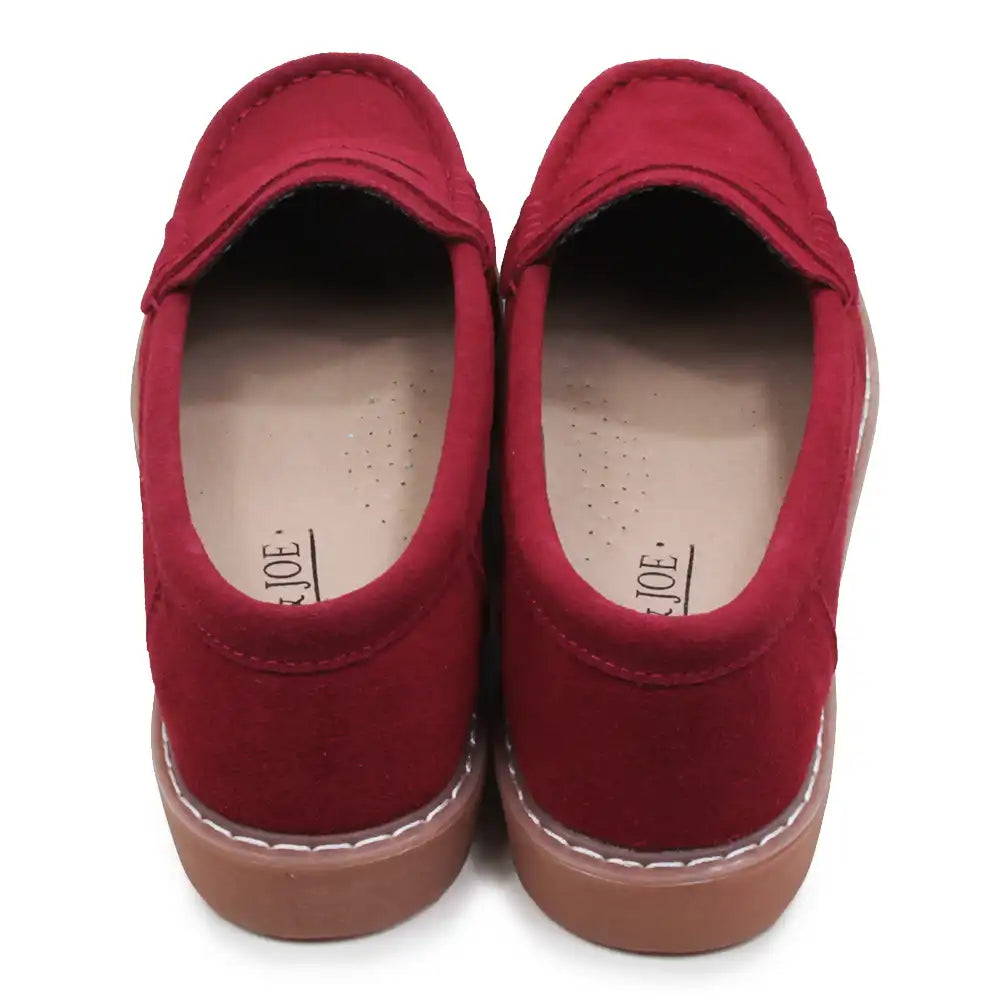 Pair of red loafers on a white background