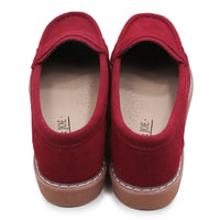 Pair of red loafers on a white background