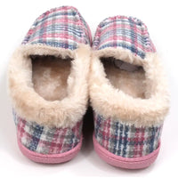 Pink and teal tartan slippers with beige/cream furry ankle cuffs. Pink rubber soles. Back view.
