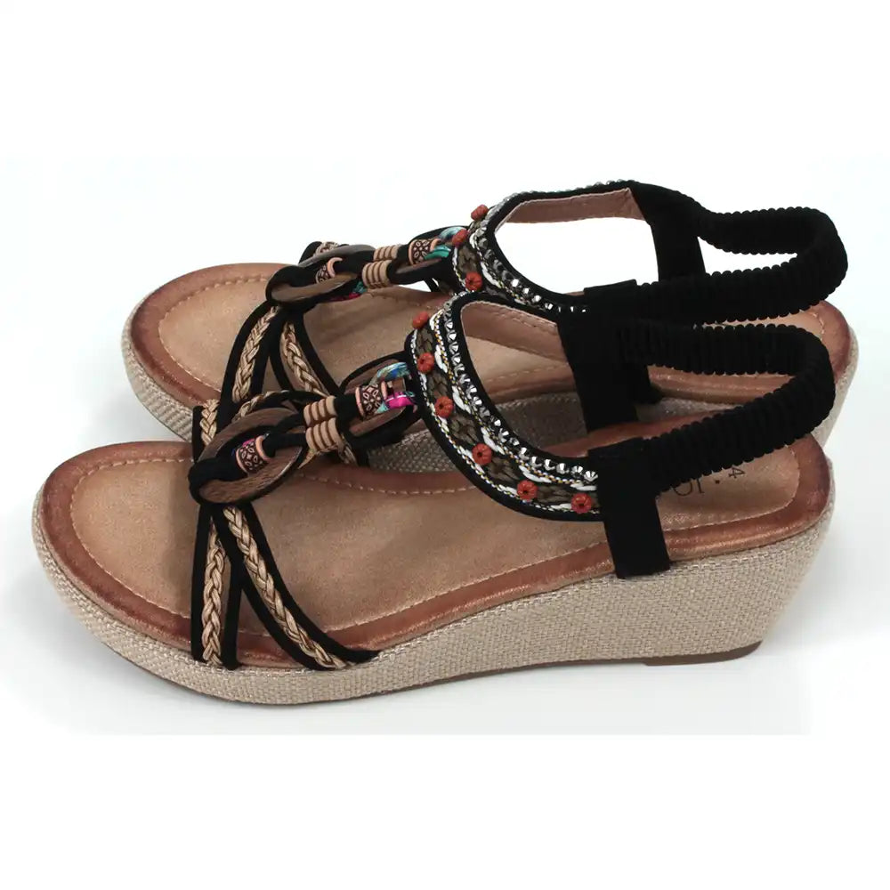 Black, strappy, wedge sandals. Peep toed with beads and fabric decoration on the straps. Elasticated slingback fitting. Hessian look wedge heels and sole sides. Side view.