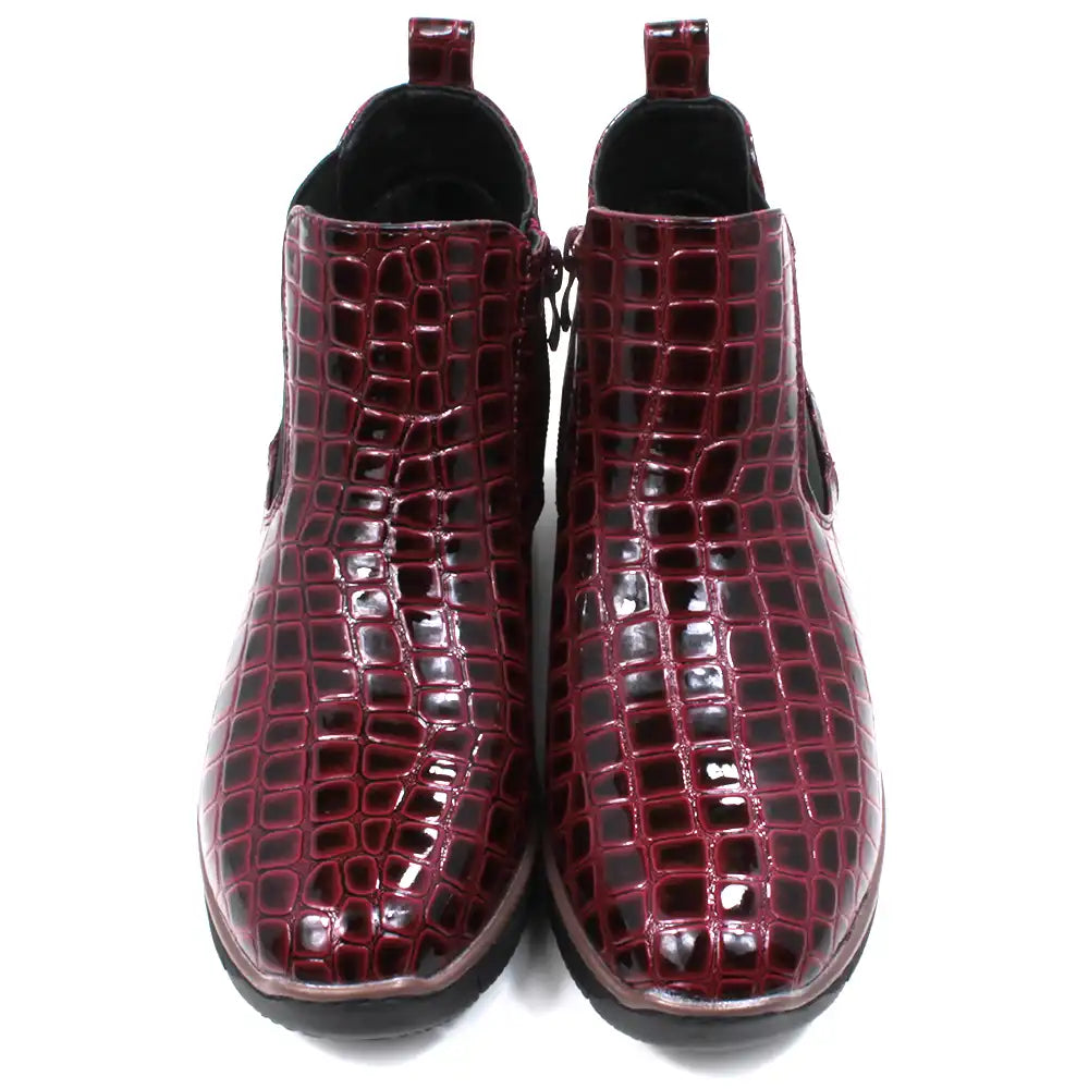 Pair of burgundy crocodile-patterned boots. Front view.