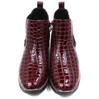 Pair of burgundy crocodile-patterned boots. Front view.