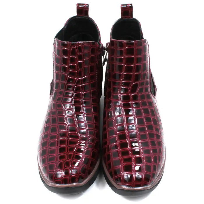 Pair of burgundy crocodile-patterned boots. Front view.