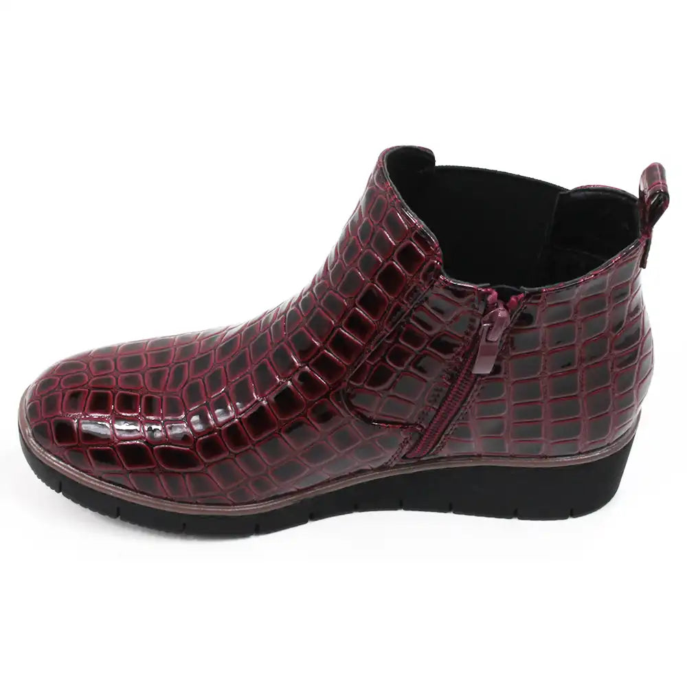 Burgundy crocodile-patterned boot. View showing zipper for fastening.