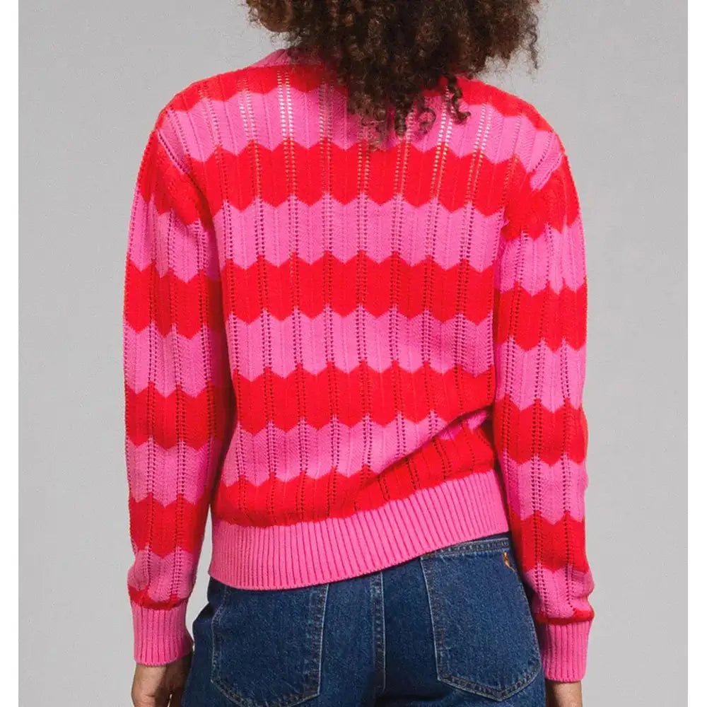 Pink and red zig zag striped cardigan with a horizontal cut out feature. Long sleeves. 