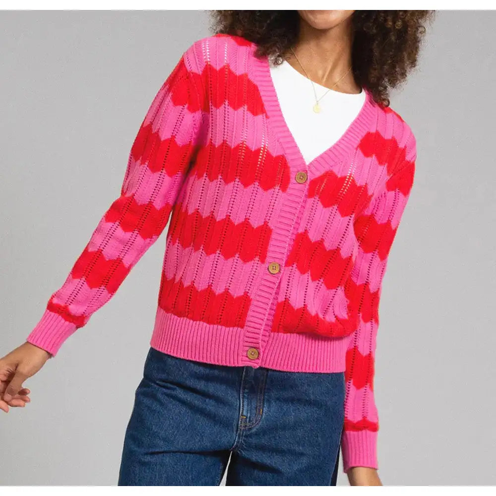 Pink and red zig zag striped cardigan with a horizontal cut out feature. Long sleeves and front buttoning. 