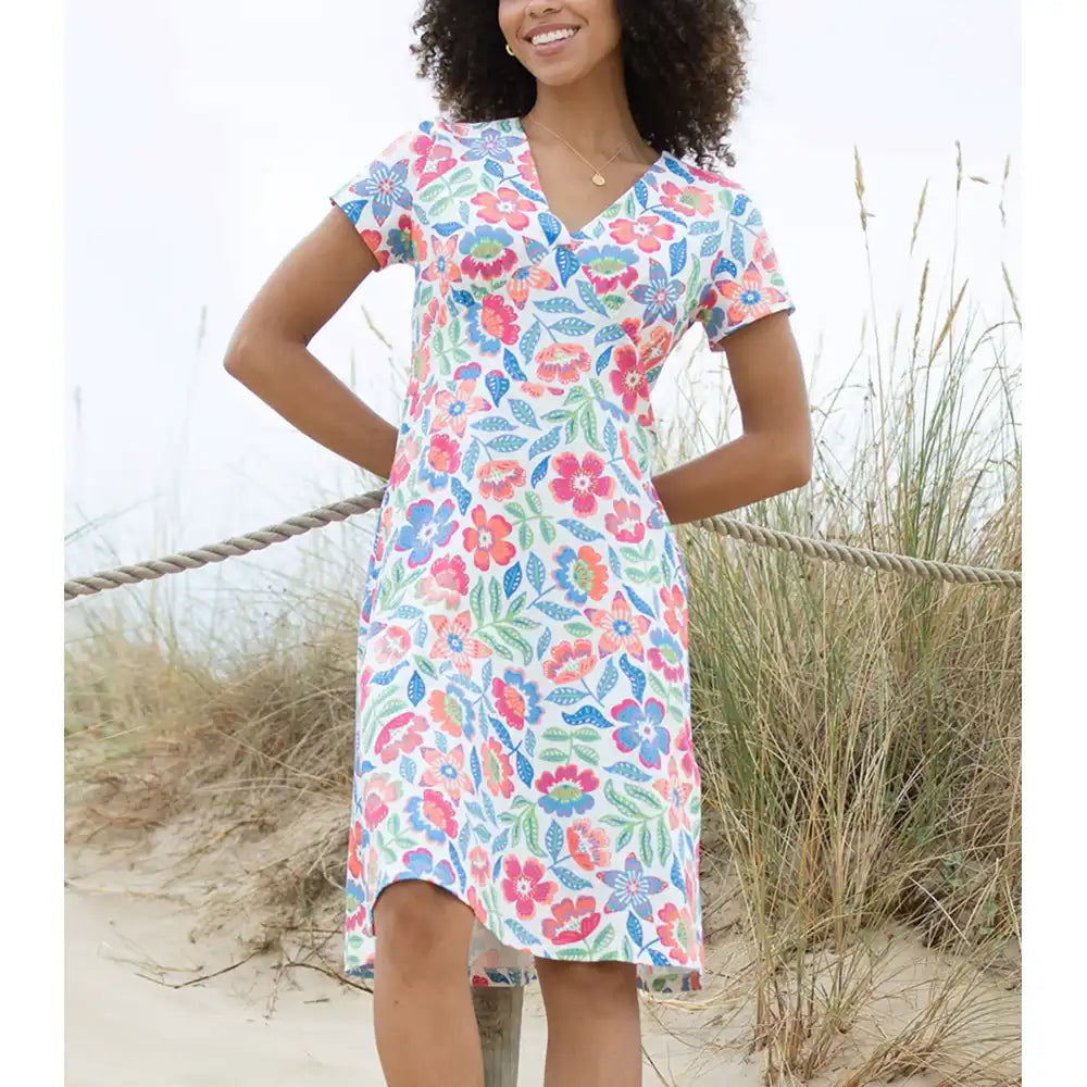 Woman wearing a floral dress on a beach