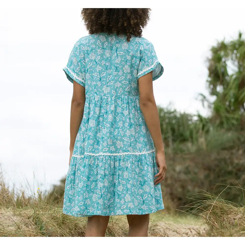 Back of a pale blue dress with a floral paisley print in white. Short sleeves