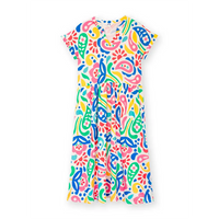 Front of a white based dress with a large rainbow coloured paisley print. Dress has short sleeves 