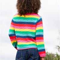 The back of a rainbow striped knitted jumper with a zig zag cut out design. 