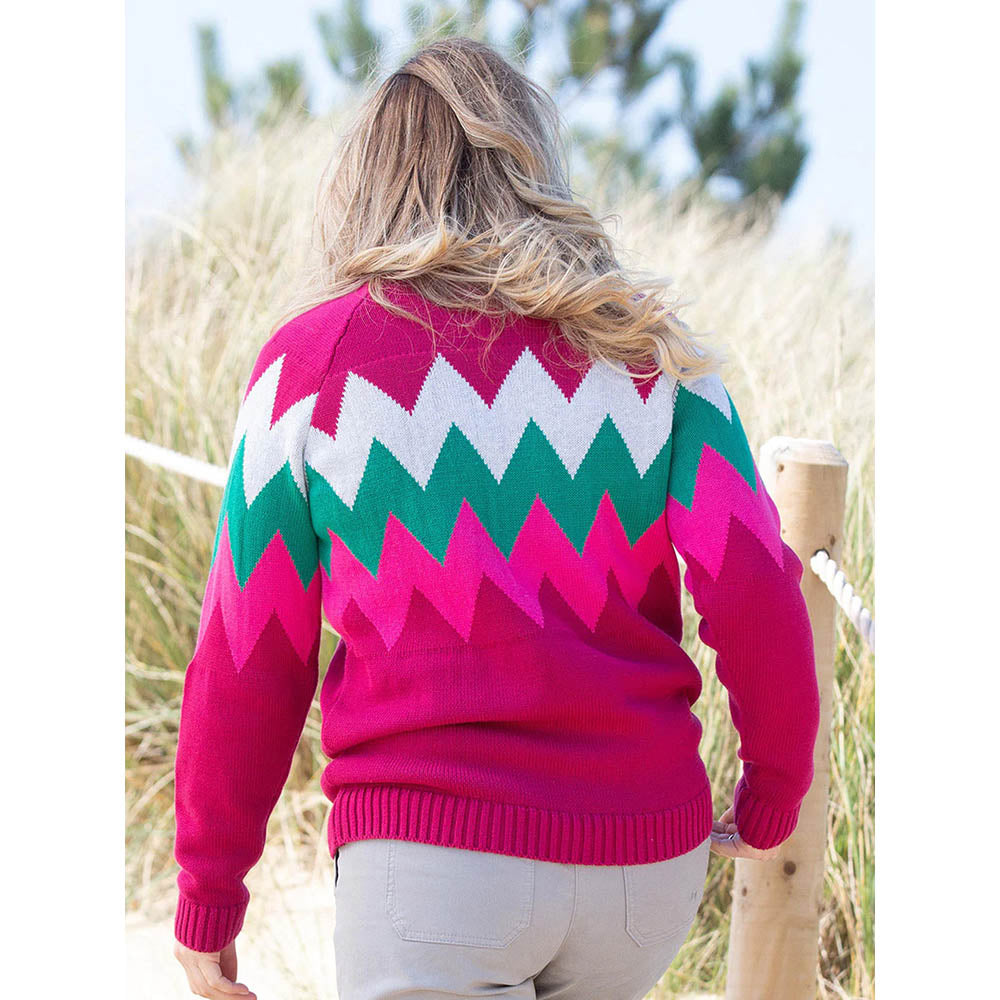 Kite bright cerise jumper with pink, green and light grey zig zag pattern. Back view.