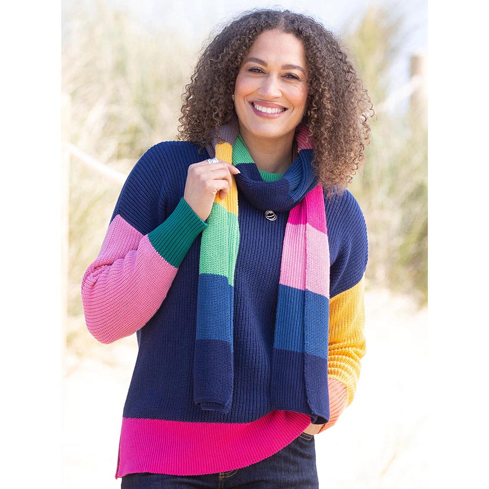 Kite knitted rainbow scarf. Worn by model. 