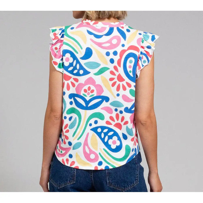 Colorful patterned top worn by a person on a gray background