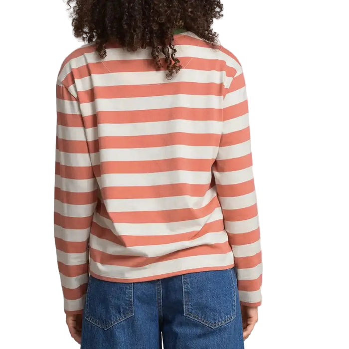 A person viewed from the back wearing a long-sleeve striped top with coral pink and off-white horizontal stripes.