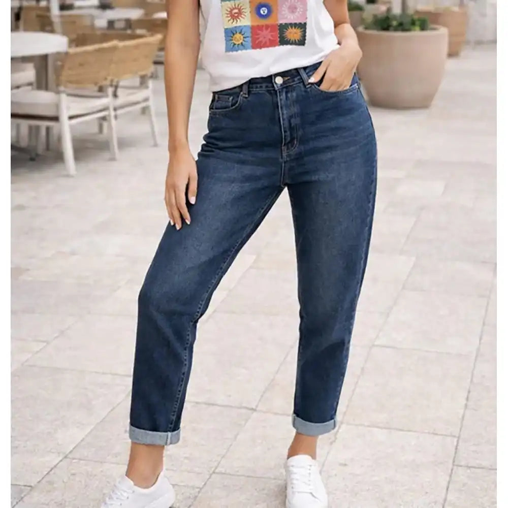 Person wearing blue jeans and a colorful shirt in an outdoor setting
