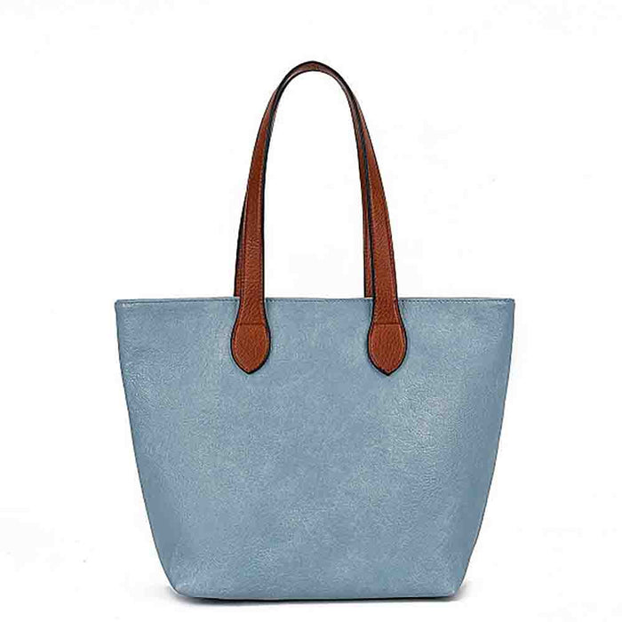 A light blue faux-leather tote bag with brown  handles, shown against a plain white background.