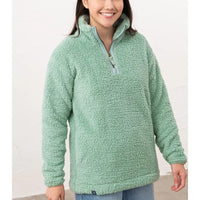 Person wearing a green fleece pullover against a white background