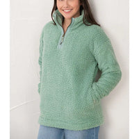 Person wearing a green fleece pullover against a white background