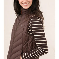A woman wearing a dark brown puffer vest over a brown and cream striped long-sleeve shirt, shown from the chest up against a plain light background.