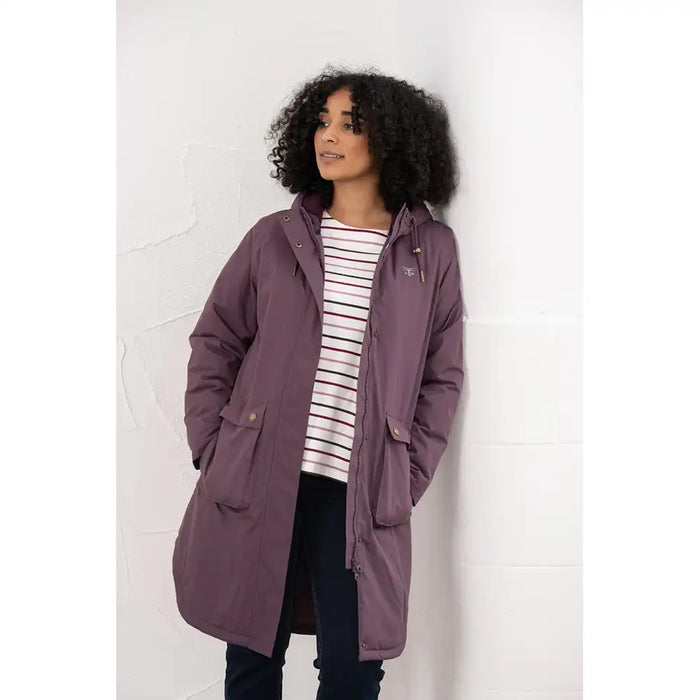Woman wearing a purple coat against a white background