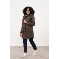 Woman wearing a long brown coat with a white background