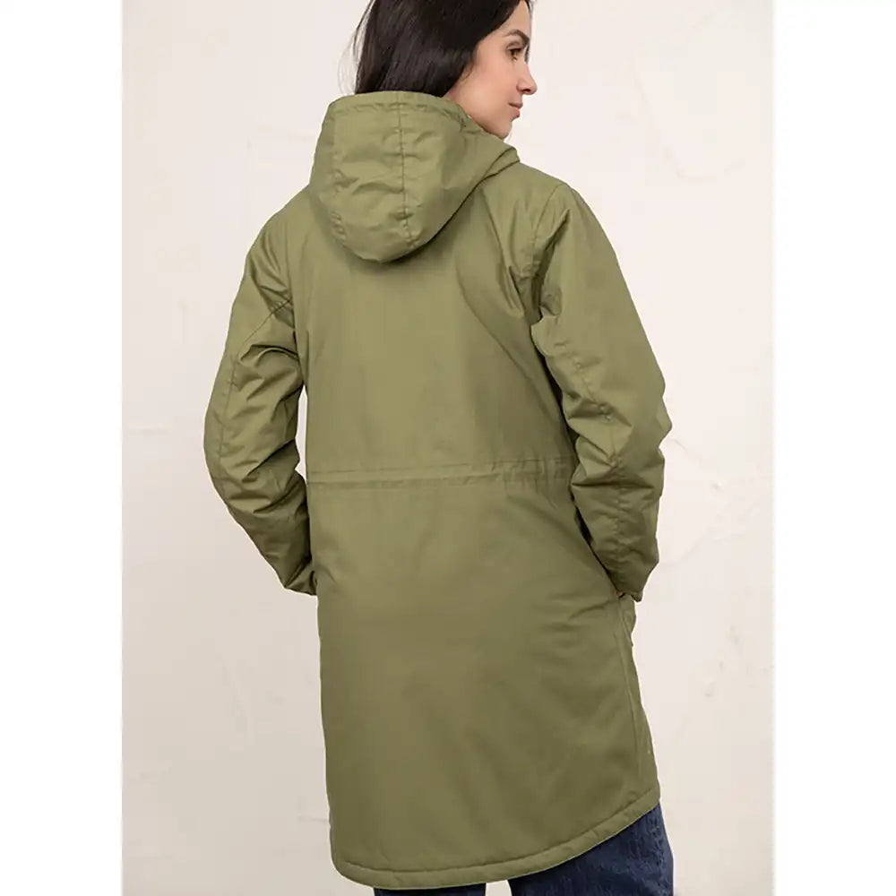 A woman shown from the back wearing a mid-length olive green hooded puffer jacket against a light off-white background.