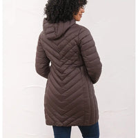 A woman shown from the back wearing a dark brown chevron-quilted hooded puffer coat, paired with dark blue jeans, against a white textured wall.
