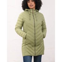 A woman wearing a light olive green hooded puffer jacket with a front zipper and drawstrings, paired with blue jeans, standing against a plain white background.
