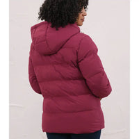 A person shown from the back wearing a quilted puffer jacket in a deep berry pink or burgundy tone, standing against a plain light wall.