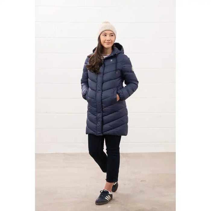 Person wearing a blue puffer coat against a white background