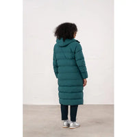 Person wearing a long teal puffer coat against a white background
