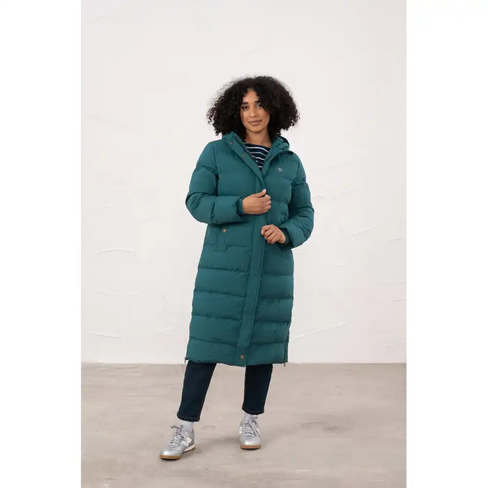 Person wearing a teal puffer coat against a white background