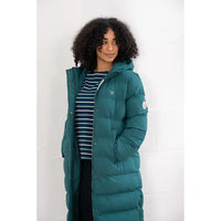 Person wearing a teal puffer coat against a white background