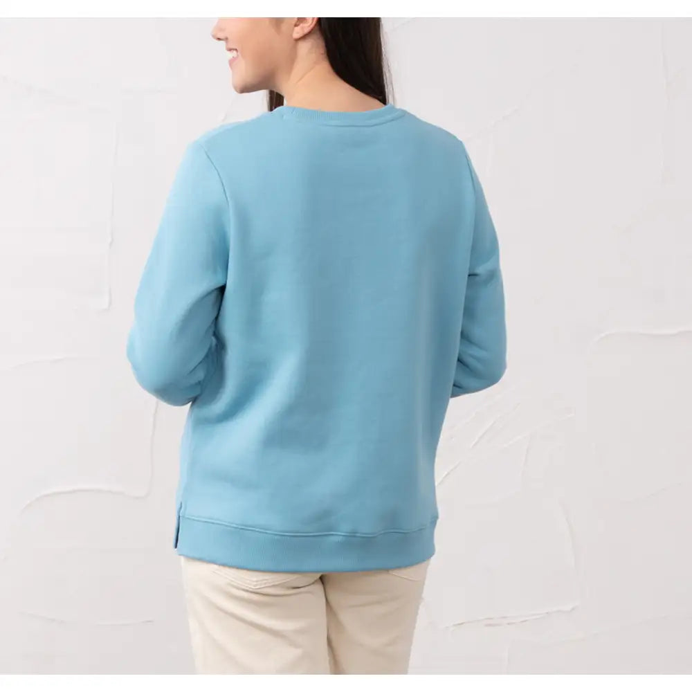 Person wearing a light blue sweatshirt against a white background