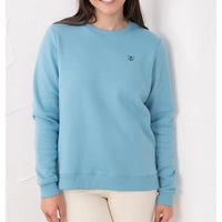 Person wearing a light blue sweatshirt with a small logo on a white background