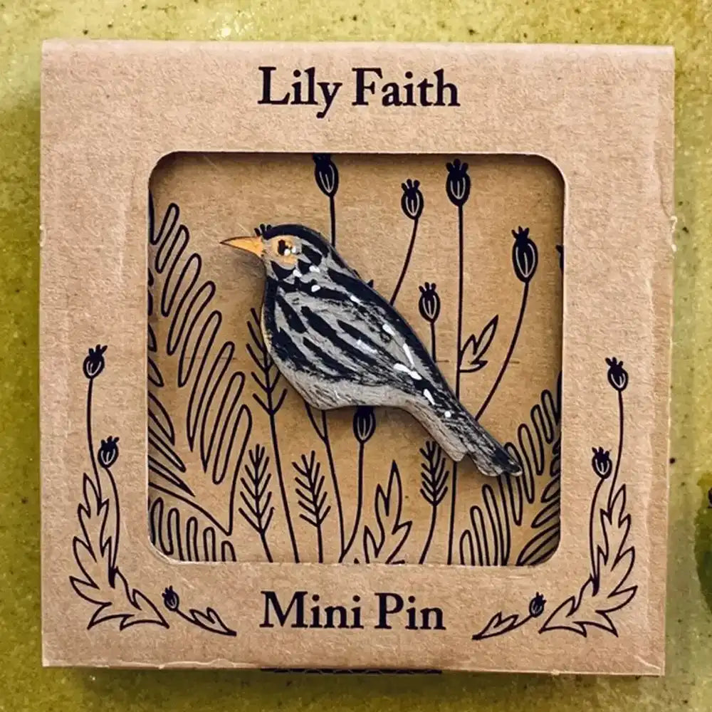 A wooden blackbird mini pin with a small yellow beak, displayed inside a square kraft paper window box labeled 'Lily Faith' and 'Mini Pin'.