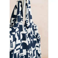 Navy blue and white patterned scarf on a beige background