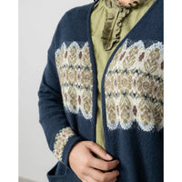 Navy blue cardigan with white floral pattern worn by a person against a light background