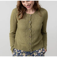 Woman wearing a green cardigan against a white background