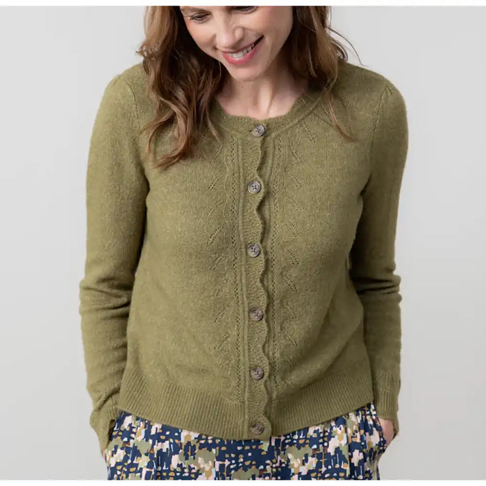 Woman wearing a green cardigan against a white background