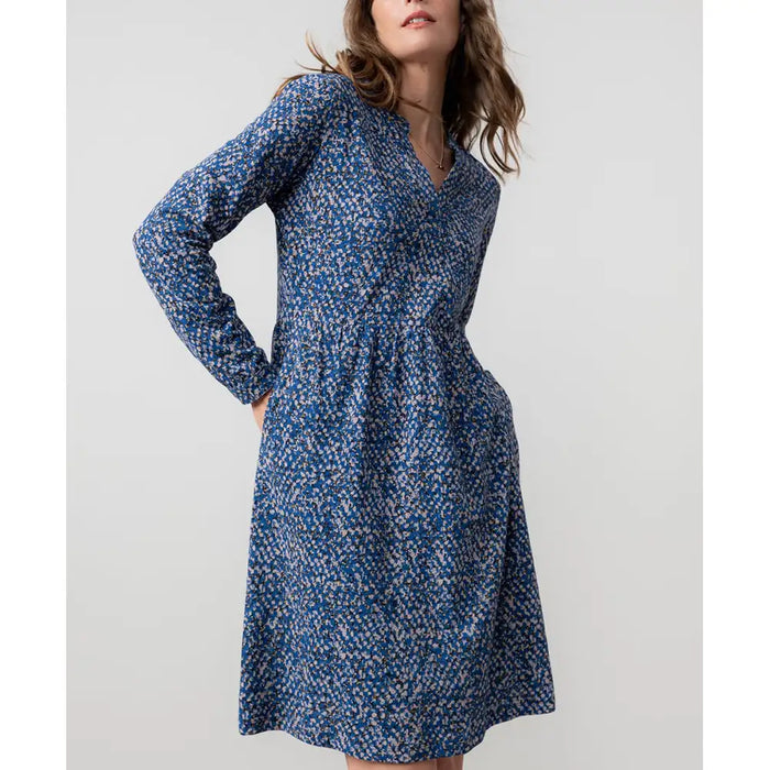 Front of a blue dapples dress with long sleeves and neckline.