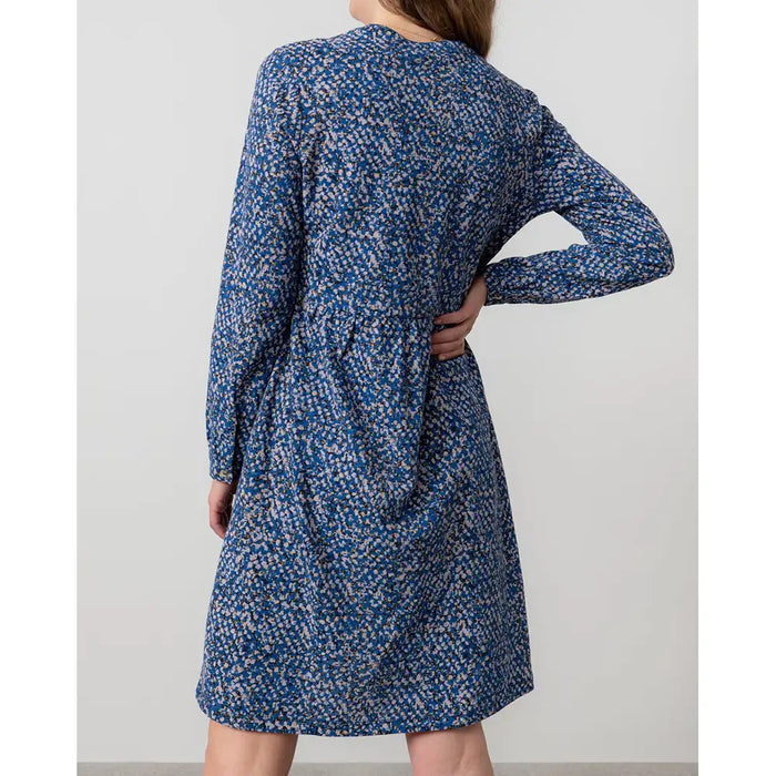 Back of a blue dapples dress with long sleeves.