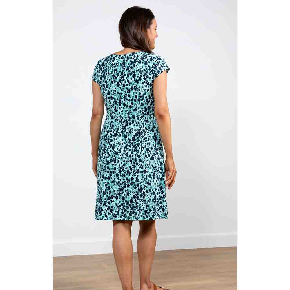 Back a sea green dress that falls to the knee with short sleeves. The print has paler sea green and navy blue clusters creating confetti print 
